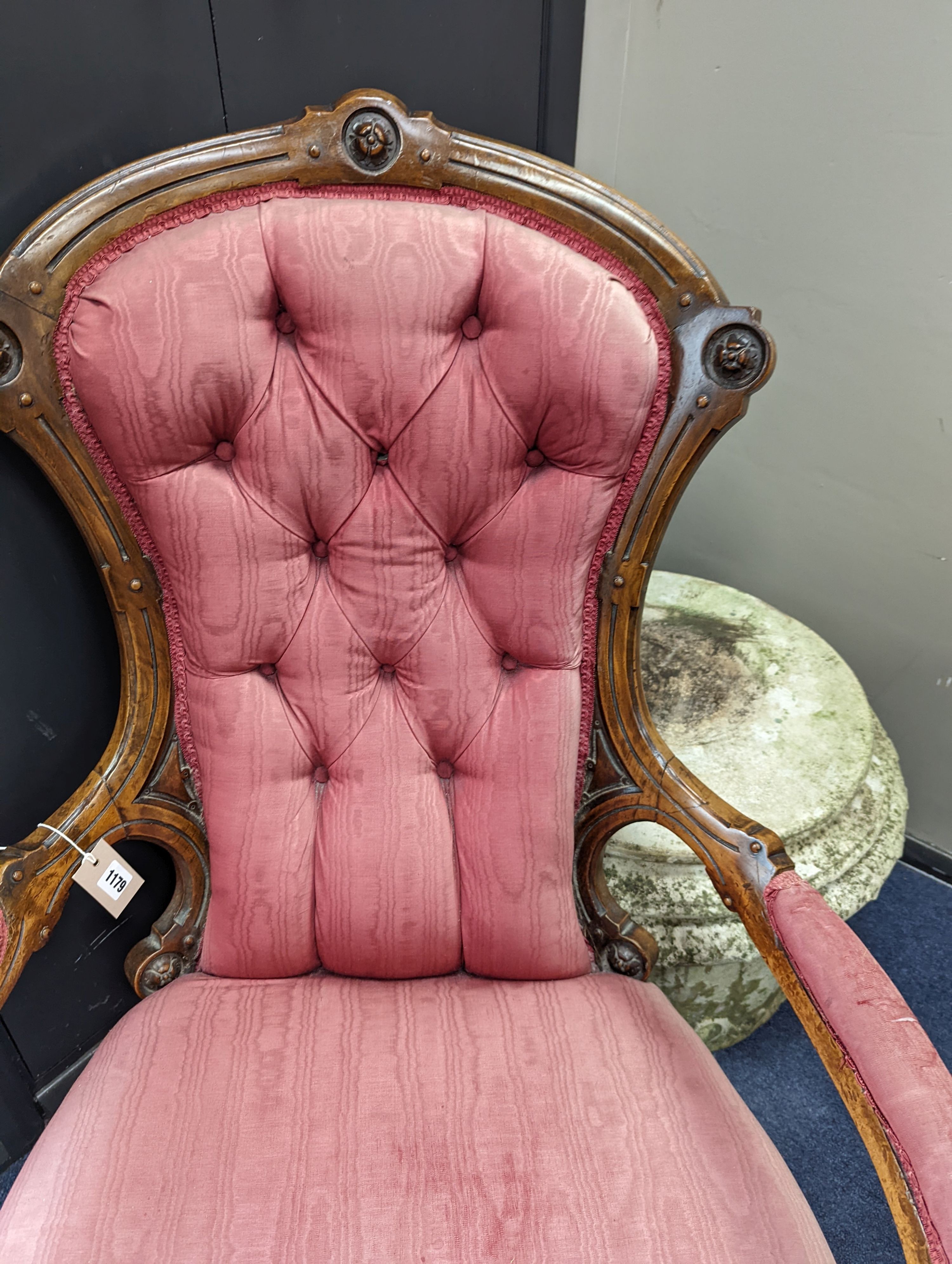 A Victorian carved walnut open armchair